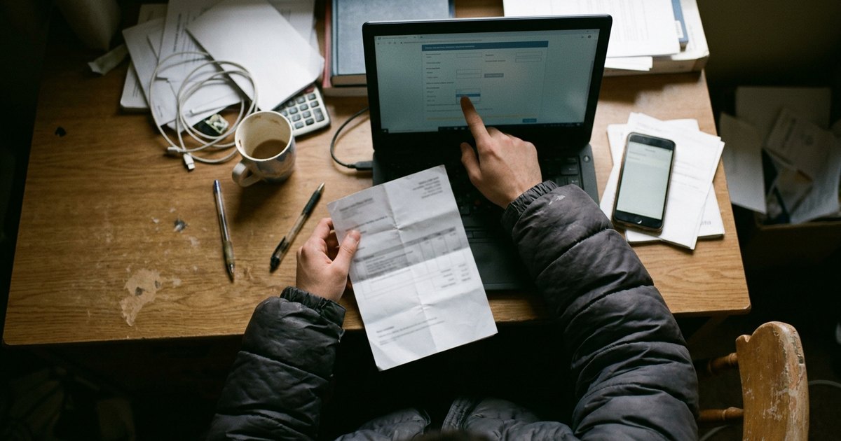 Overhead view of hands adjusting a deadline on an essay price calculator next to a printed quote.